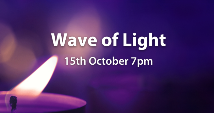 A lit candle with dark purple background and the text Wave of Light 15th October 7pm